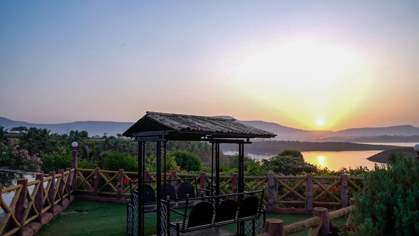 Sunlight over the lake and pavilion at Fazlani Nature’s Nest