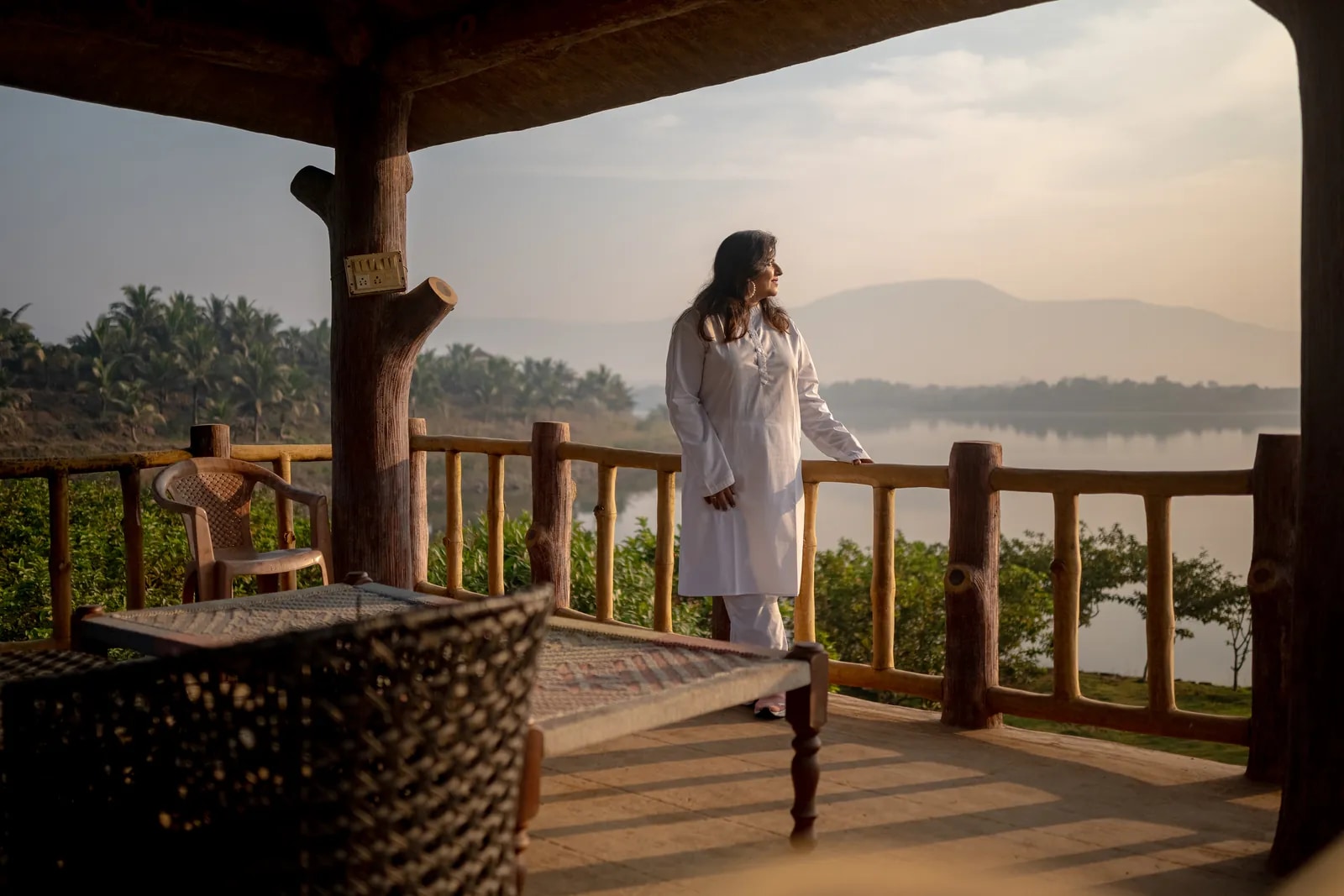 A guest overlooking the lake from a covered veranda